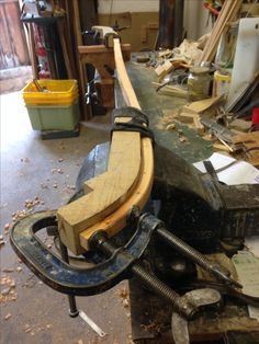 a clamp is sitting on top of a workbench in a workshop with tools