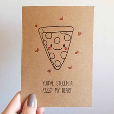 a hand holding up a card with a pizza on it that says you've stolen a pizza my heart