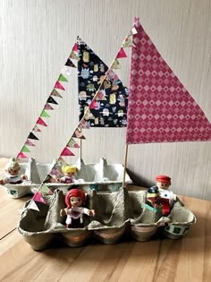 an egg carton filled with toys on top of a wooden table