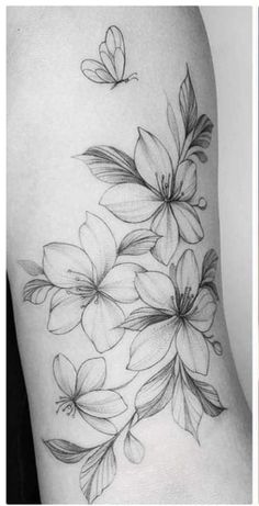 two different tattoos with flowers and butterflies on the side of their thighs, one is black and