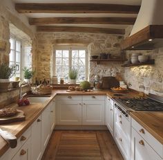 a kitchen with white cabinets and wooden counter tops, along with an oven in the center