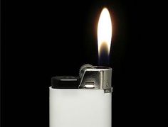 a lighter is lit on a black background