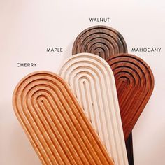 four wooden paddles stacked on top of each other in the shape of circles and rectangles