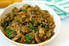 a white bowl filled with rice and mushrooms