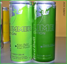 two cans of energy drink sitting on top of a counter