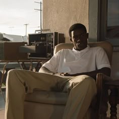 a man sitting in a chair on the porch