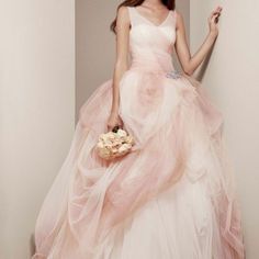 a woman in a pink dress holding a bouquet