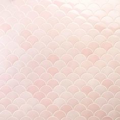 an abstract pink and white tile pattern with wavy shapes on the bottom half of it