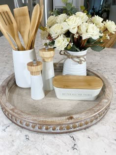 a tray with utensils and flowers on it