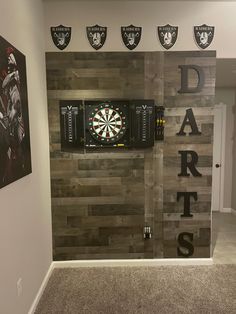 a dart room with darts on the wall