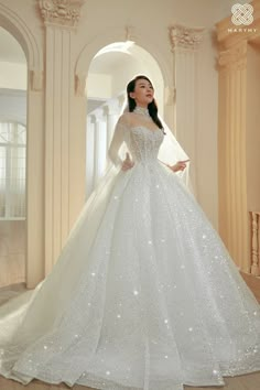 a woman in a white wedding dress posing for the camera