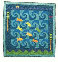 a quilted wall hanging with fish on it