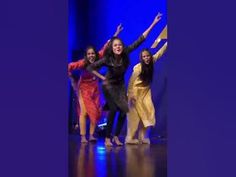 the group of women are dancing on the stage