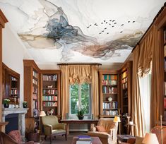 a living room filled with furniture and a painting on the ceiling