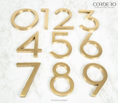 gold numbers and numerals on a marble surface