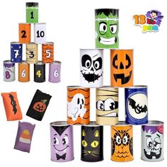 halloween themed candles are stacked up in the shape of pumpkins and ghostes with faces on them