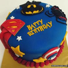 a blue birthday cake with batman and spiderman decorations