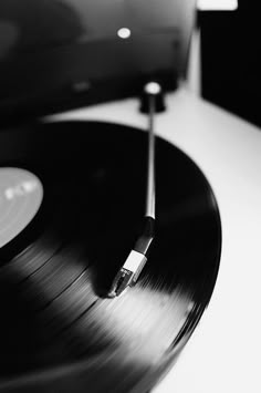 an old record player is sitting on the table with it's turntable in black and white