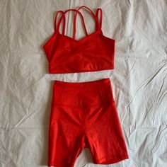 Selling This Never Worn Workout Set From Girlfriend Collective. The Set Is Made From Their Float Fabric Which Is Less Compressive Than Their Other Clothing. The Color Is A Bright Orangey Red Called Racer. Bra Is Sold Out Online. Both Are Size Xs Originally Purchased For $90, Selling The Set For $50. I'd Prefer To Sell Both Pieces At Once But Let Me Know If You're Just Interested In One. Solid Color Sports Sets For Summer, Athleisure Workout Sets With Shorts, Red Sports Sets For Spring, Red Biker Shorts For Summer Workouts, Summer Red Athletic Shorts For Yoga, Girlfriend Collective, Workout Sets, Shorts Athletic, Athletic Shorts