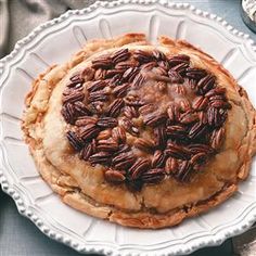 a pecan pie sitting on top of a white plate