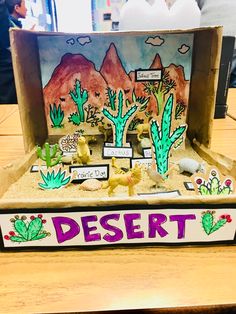 a desert scene made out of cardboard on a table