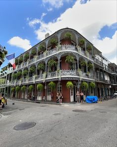 an old building with many balconies and plants on it