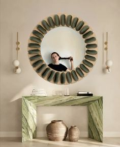 a woman is taking a selfie in the mirror with her hair dryer on