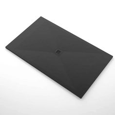 an empty black envelope sitting on top of a white surface with a small square hole in the middle