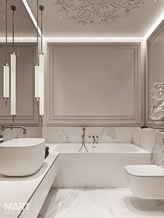 a bathroom with two sinks and a bathtub next to a toilet under a chandelier