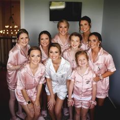 a group of women in pink pajamas posing for a photo