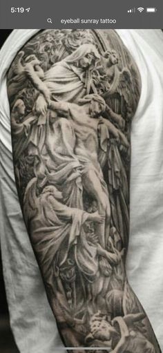 a man with a tattoo on his arm that has an image of the crucifix