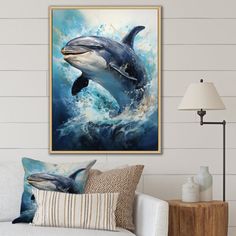 a dolphin jumping out of the water in front of a white couch with pillows on it