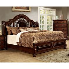 a bedroom with a bed, dresser and mirror on the wall next to hardwood flooring