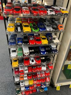 there are many toy cars on the shelves in this store that is filled with them