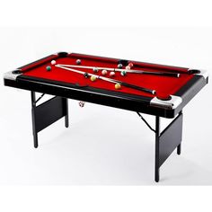 a red pool table with two cues and balls on the top, in front of a white background