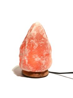 a rock with a wire attached to it that is covered in pink and white crystals