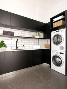 a washer and dryer sitting in a kitchen next to each other on the floor