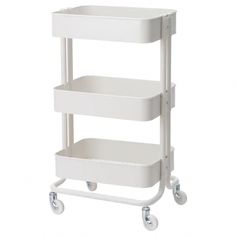 a white cart with three shelves and wheels on the bottom, in front of a white background