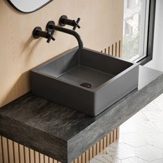 a bathroom sink sitting on top of a wooden counter next to a wall mounted mirror