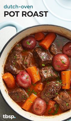 a pot filled with meat, potatoes and carrots on top of a white table