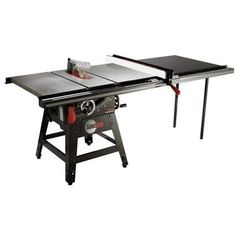 the table saw is sitting on top of a workbench with two tables attached to it