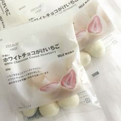 two packets of white chocolate covered strawberries in japanese writing on the front and back