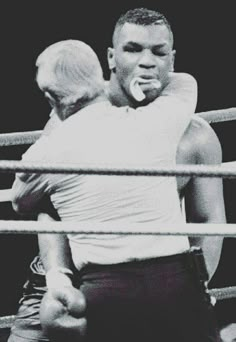 a man and woman standing next to each other in a boxing ring