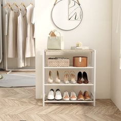 a white shelf filled with shoes next to a mirror and clothes rack on the wall