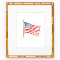 an american flag is displayed in a gold frame