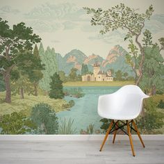 a white chair sitting in front of a wall mural