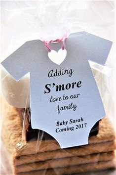 some cookies are stacked on top of each other with a tag that says, adding s'more love to our family