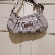 Coach Bag Poppy Collection Gray And Silver Sparkle Fleck Signature C Pattern Never Used The Front Has The Leather Logo In Silver Of Coach Poppy Collection As Well As The Front Pocket Zipper Pull Tab. There Are Also Logo Tags Hanging From The Handle. The Inside Is Mauve Pink With A Traditional Back Zipper. Excellent Condition And Smoke Free Home, Dr71523 Coach Poppy Bag, Silver Designer Shoulder Bag With Detachable Strap, Designer Silver Bag With Detachable Strap, Designer Silver Shoulder Bag With Palladium Hardware, Formal Silver Shoulder Bag With Removable Pouch, Formal Gray Bag With Silver-tone Hardware, Designer Silver Bags With Silver-tone Hardware, Designer Silver Crossbody Bag, Silver Bags For Everyday Use