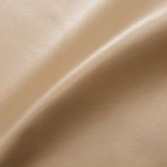 a close up view of a beige leather textured material that is very soft and smooth