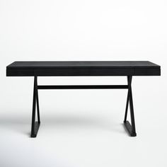 a black table sitting on top of a white floor next to a wooden frame and metal legs